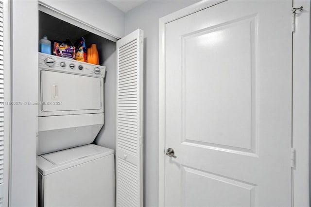 laundry area with stacked washing maching and dryer