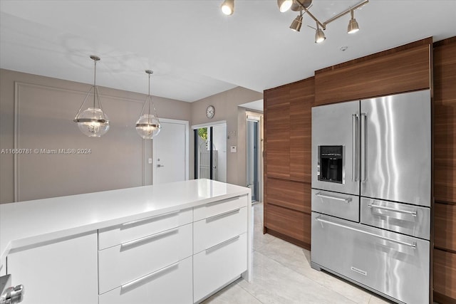 kitchen with white cabinetry, light tile patterned floors, pendant lighting, and high end fridge