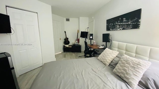 bedroom with a closet and light hardwood / wood-style floors