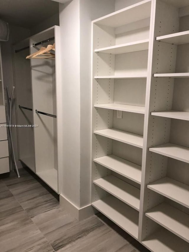 walk in closet featuring hardwood / wood-style floors