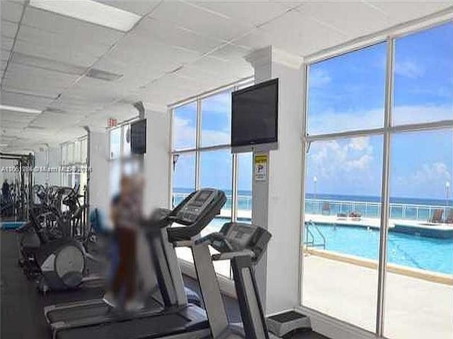 gym with a paneled ceiling