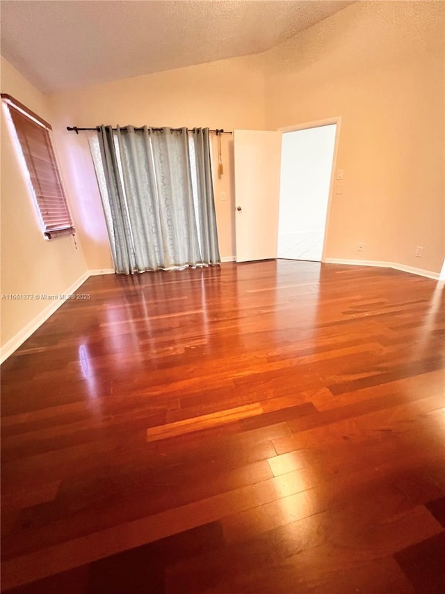 unfurnished room featuring a textured ceiling and hardwood / wood-style flooring