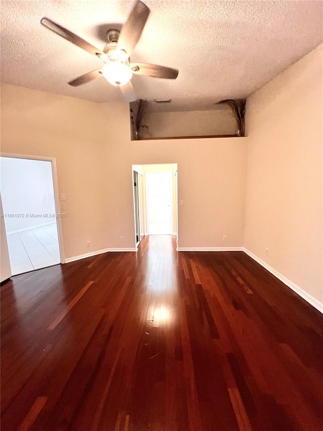 spare room featuring ceiling fan, wood-type flooring, and a textured ceiling