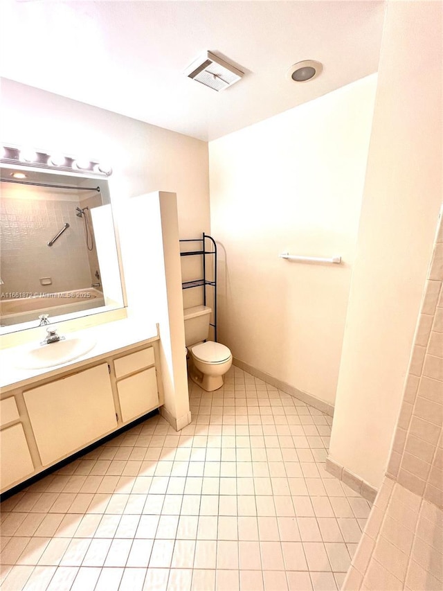 bathroom with tile patterned flooring, vanity, and toilet