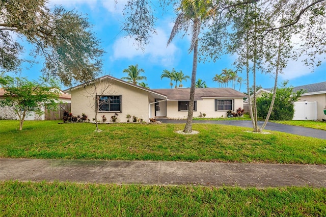 single story home featuring a front yard