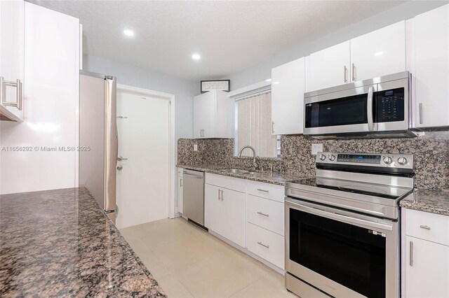 11533 SW 59th Ct, Cooper City, FL 33330 - kitchen with stainless steel appliances, backsplash, white cabinets, dark stone countertops, and recessed lighting