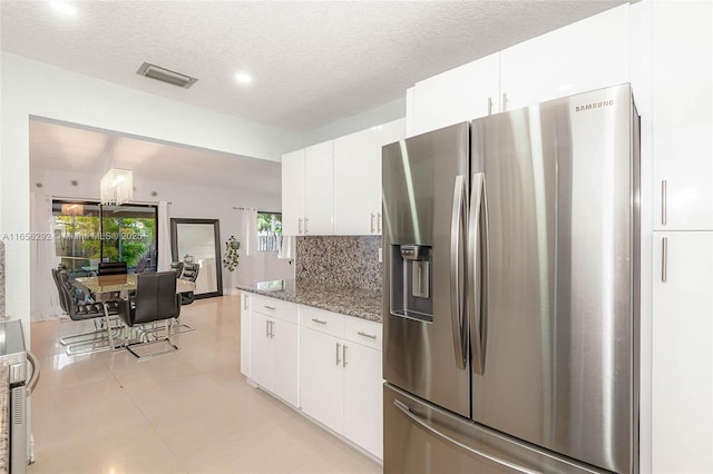 11533 SW 59th Ct, Cooper City, FL 33330 - kitchen with stainless steel refrigerator with ice dispenser, dark stone countertops, white cabinets, decorative backsplash, and a textured ceiling