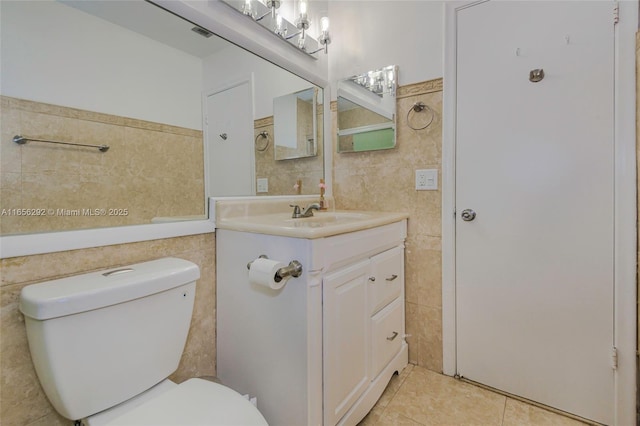 11533 SW 59th Ct, Cooper City, FL 33330 - bathroom featuring tile walls, vanity, tile patterned flooring, and a wainscoted wall