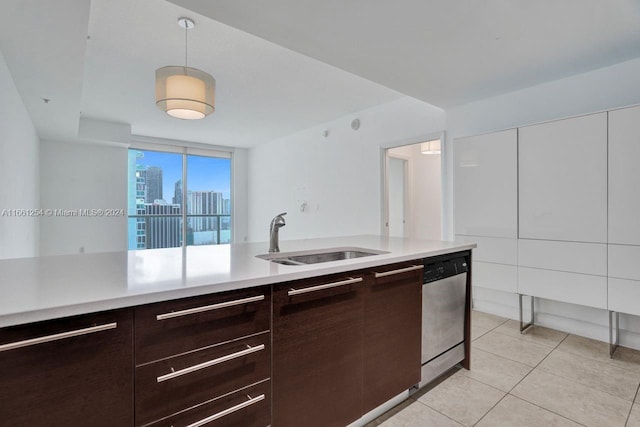 kitchen featuring white cabinets, light tile patterned floors, sink, dark brown cabinets, and dishwasher