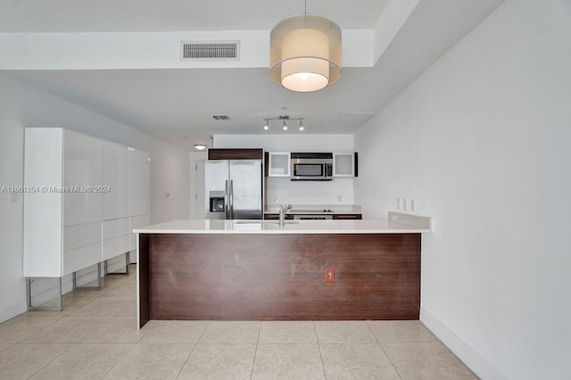 kitchen featuring kitchen peninsula, appliances with stainless steel finishes, and light tile patterned floors