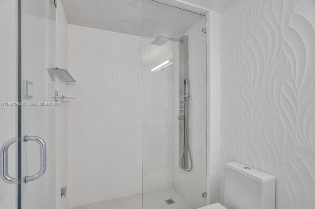 bathroom with walk in shower, tile walls, and toilet