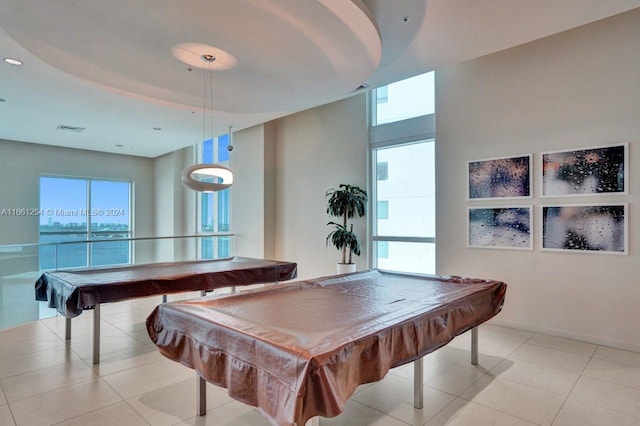 rec room with a water view, pool table, and light tile patterned flooring