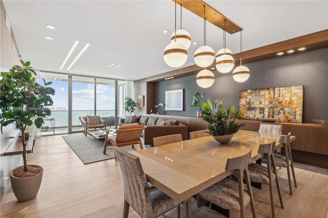 dining area featuring expansive windows and a water view