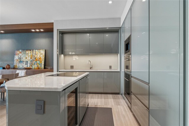18975 Collins Ave Unit 4502, Sunny Isles Beach, FL 33160 - kitchen featuring modern cabinets, gray cabinetry, stainless steel appliances, and beverage cooler