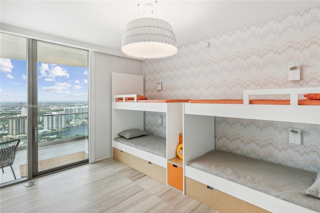 unfurnished bedroom featuring a water view and access to outside