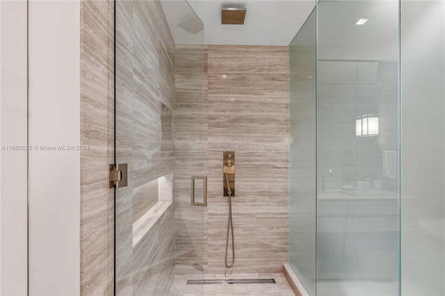 bathroom featuring a shower with shower door