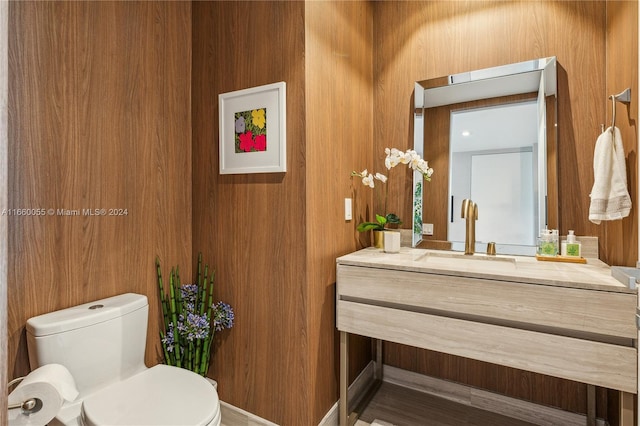 18975 Collins Ave Unit 4502, Sunny Isles Beach, FL 33160 - bathroom featuring vanity, toilet, and wood walls