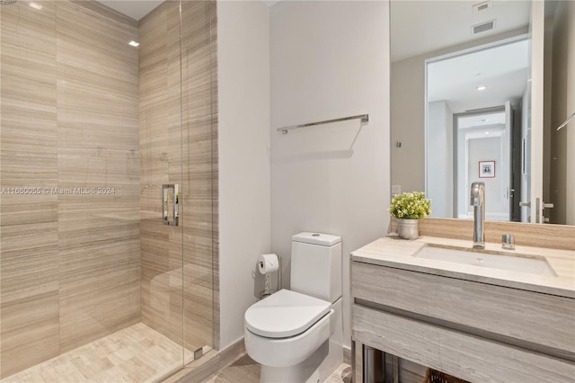 bathroom with wood-type flooring, vanity, a shower with shower door, and toilet