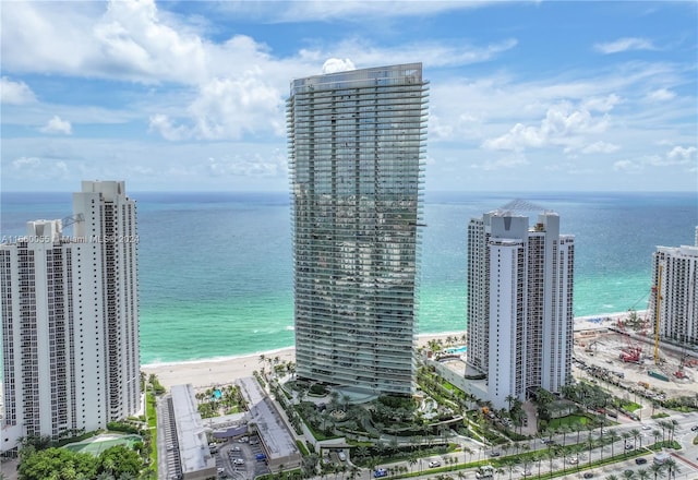 drone / aerial view featuring a beach view and a water view