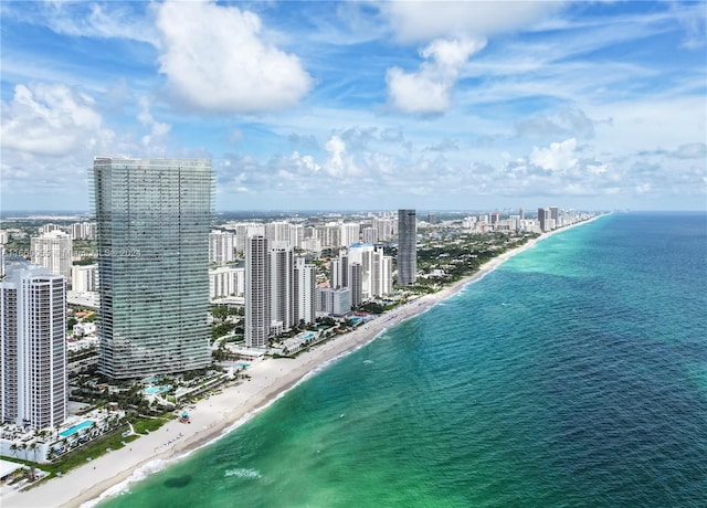 drone / aerial view featuring a beach view and a water view