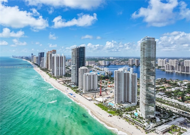 birds eye view of property featuring a view of the beach and a water view