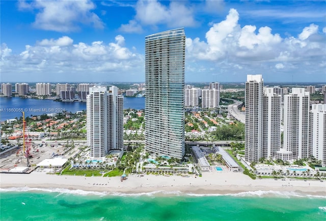 birds eye view of property with a water view and a view of the beach