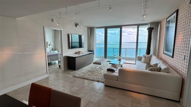 living room with rail lighting and floor to ceiling windows