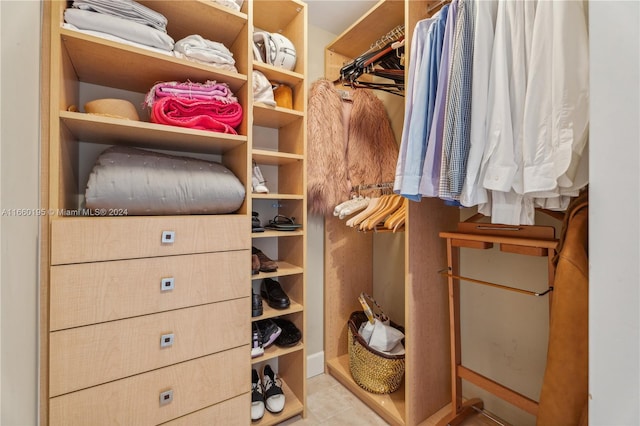 spacious closet featuring light tile patterned floors