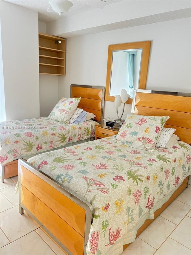 bedroom with tile patterned flooring and ceiling fan