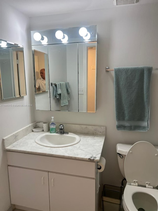 bathroom with vanity and toilet