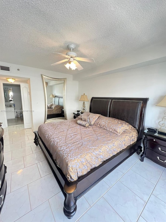 bedroom featuring a textured ceiling and ceiling fan