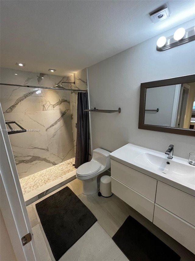 bathroom with walk in shower, vanity, and toilet