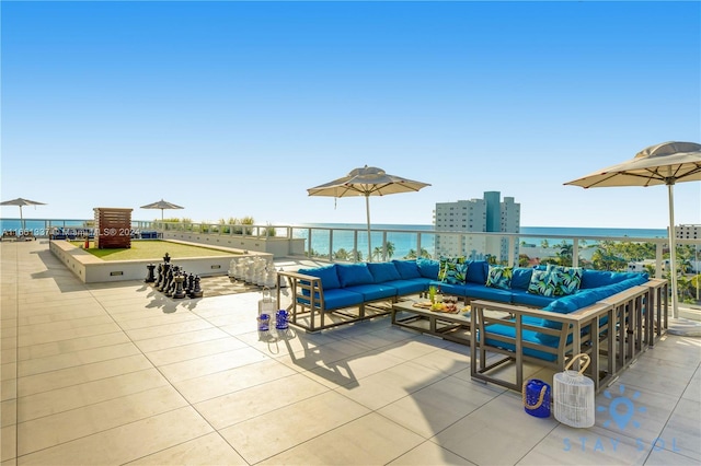 view of patio with an outdoor living space and a water view