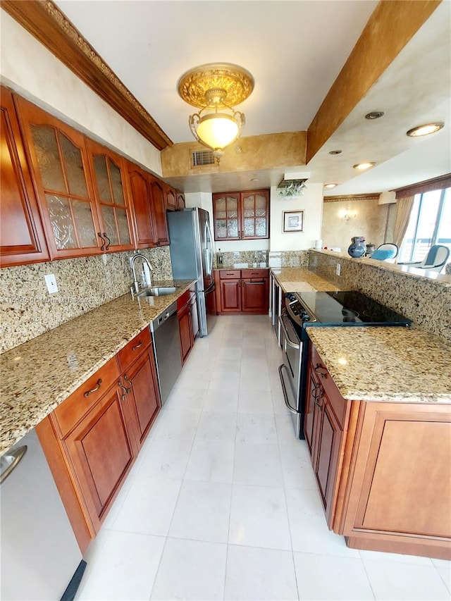 kitchen featuring light tile patterned floors, sink, tasteful backsplash, appliances with stainless steel finishes, and light stone countertops