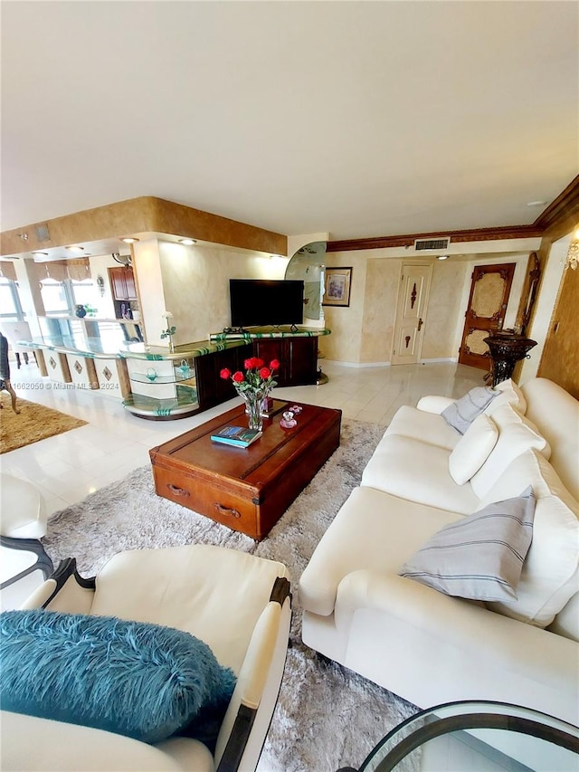 living room featuring crown molding and light tile patterned flooring