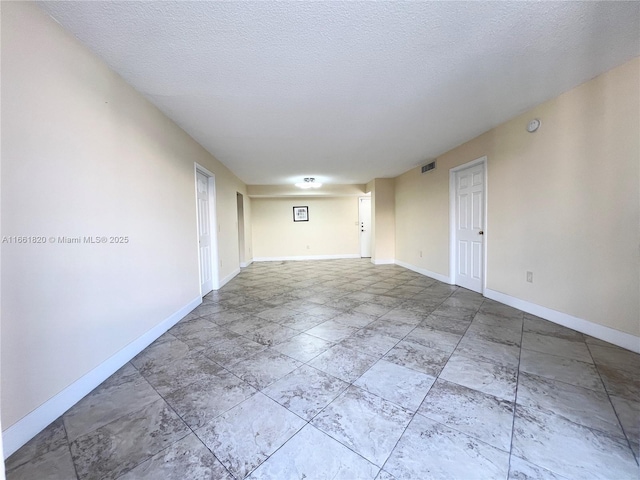 spare room with a textured ceiling