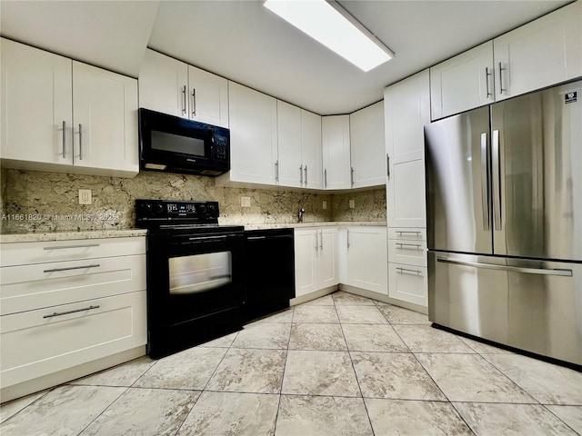 kitchen with black appliances, decorative backsplash, white cabinets, and light tile patterned floors