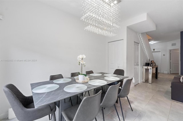 tiled dining room featuring an inviting chandelier