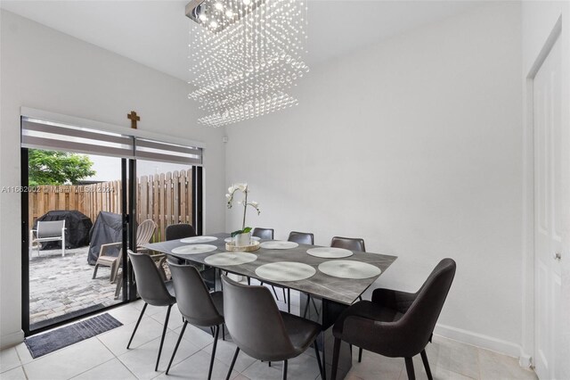 tiled dining area featuring a notable chandelier