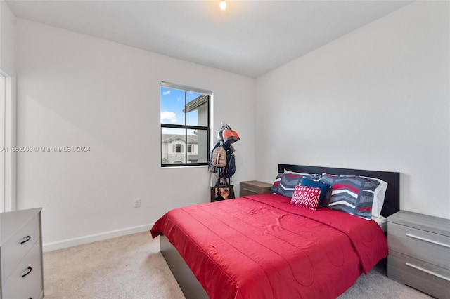 bedroom featuring light carpet