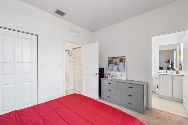 carpeted bedroom with a closet and sink