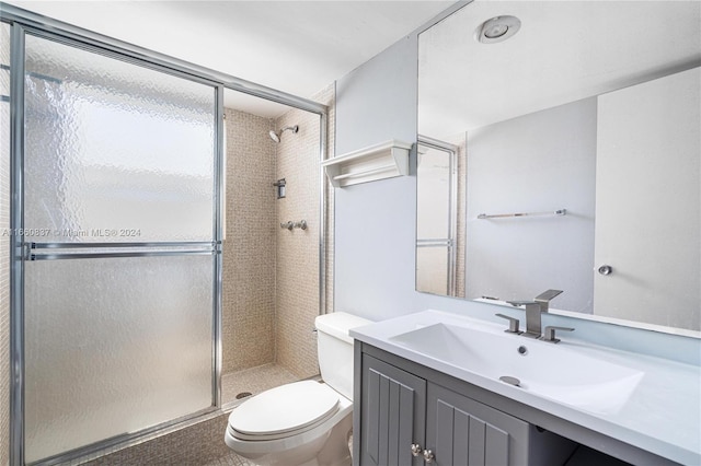 bathroom featuring walk in shower, vanity, and toilet