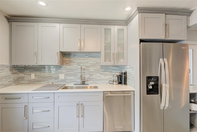 kitchen featuring stainless steel appliances, tasteful backsplash, and sink