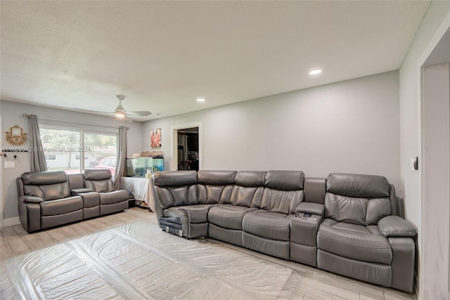 living room featuring light hardwood / wood-style floors and ceiling fan