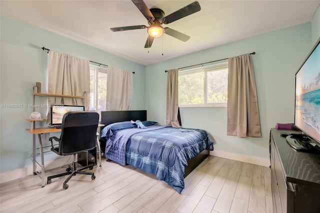 bedroom with ceiling fan and light hardwood / wood-style flooring