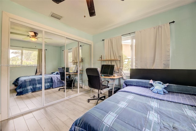 bedroom with a closet, ceiling fan, and hardwood / wood-style flooring