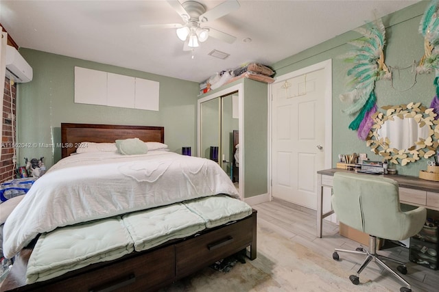 bedroom featuring ceiling fan, light hardwood / wood-style flooring, a closet, and a wall mounted AC