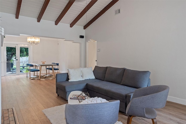 living room with a notable chandelier, light hardwood / wood-style flooring, high vaulted ceiling, and beamed ceiling