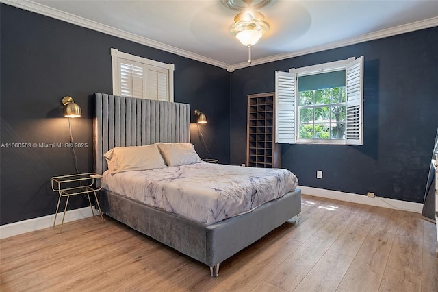 bedroom featuring crown molding, ceiling fan, and light wood-type flooring