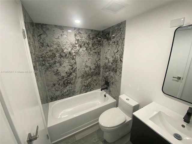 full bathroom with vanity, tiled shower / bath combo, and toilet